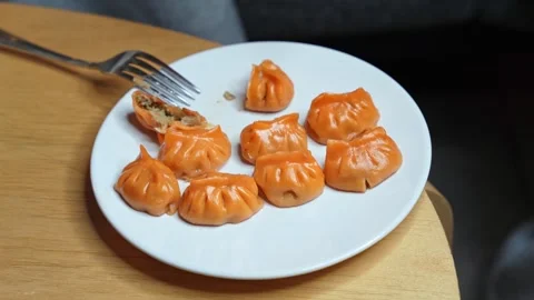 Fork Piercing Orange Asian Dumpling On Plate Stock Footage 340829491