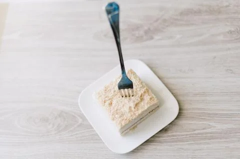 A fork is on a plate with a piece of cake Stock Photos
