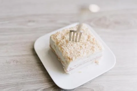 A fork is on a plate with a piece of cake Stock Photos
