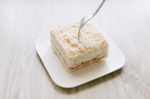 A fork is on a plate with a piece of cake Stock Photos