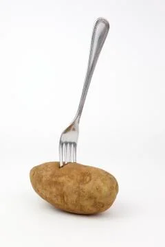 Fork in a potato Stock-Fotos