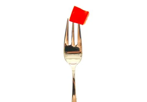 Fork with a red pepper slice isolated on white background. Stock Photos