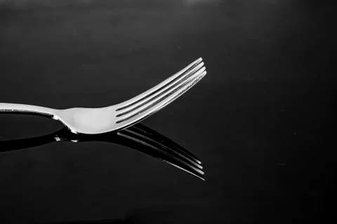 Fork with reflection only the head with tines in silver metallic Stock Photos