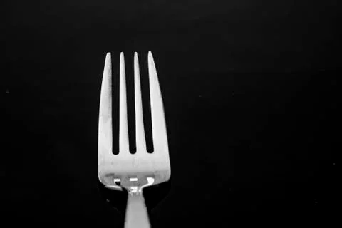 Fork with reflection only the head with tines in silver metallic Stock Photos
