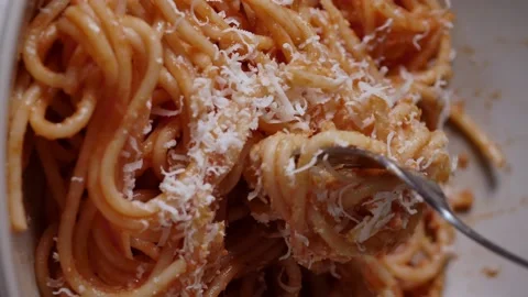 Fork rolling spaghetti. Close Up view. Red tomato spaghetti with parmesan cheese Stock Footage 230421658
