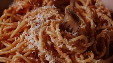 Fork rolling spaghetti. Close Up view. Red tomato spaghetti with parmesan cheese Stock Footage 230426973