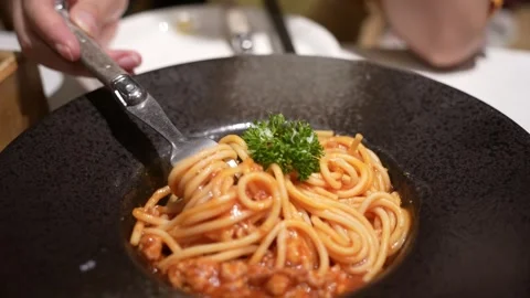 Fork rolling spaghetti. Close Up view. Red tomato spaghetti with parmesan che Video stock 321273004