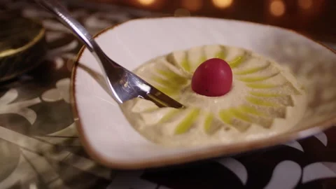 Fork scooping fresh hummus from a bowl in an Arabic restaurant Stock Footage 345145911