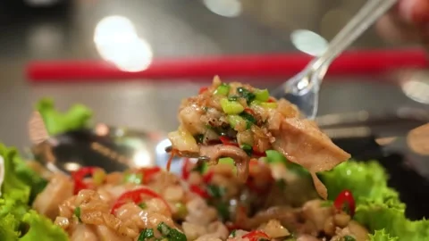 Fork Scooping Thai Stir-Fried Minced Chicken with Holy Basil on Lettuce Stock Footage 344230583