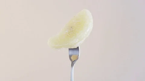 Fork With a Single Piece of Orange on Almond Background Stock Footage 70535996