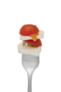 Fork with slice tomato and cheese Stock Photos