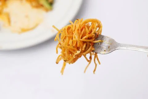 Fork with spaghetti pasta on a white background Stock Photos