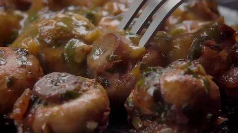 A fork spears and lifts a fried mushroom Stock Footage 296298611