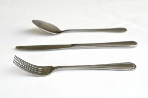 Fork spoon and knife on the table Stock Photos