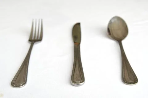 Fork spoon and knife on the table Stock Photos