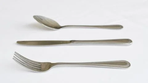 Fork spoon and knife on the table Stock Photos