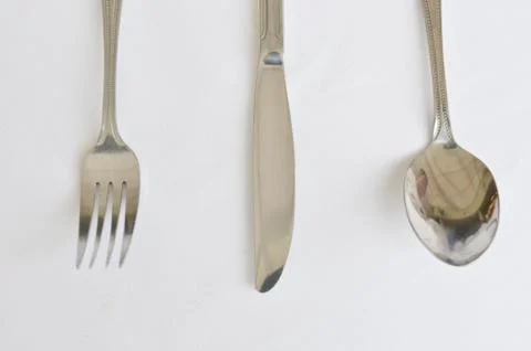 Fork spoon and knife on the table Stock Photos