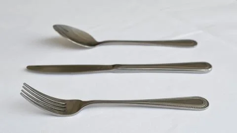 Fork spoon and knife on the table Stock Photos