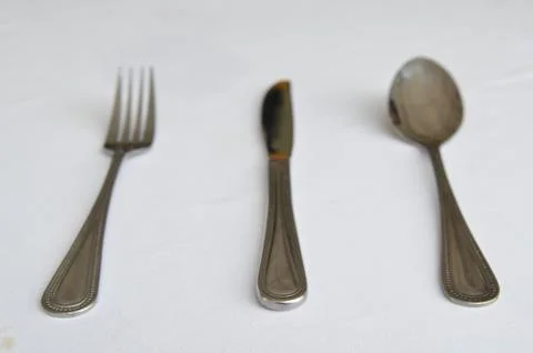 Fork spoon and knife on the table Stock Photos