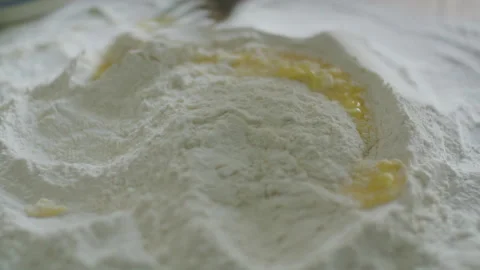 Fork Stirring Eggs in Well of Flour Stock Footage 288811070