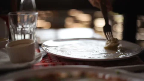 A fork strands the last dumpling from a plate, Close-up Vidéo 150275530