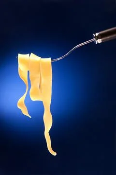 Fork with tagliatelle on a red background Stock Photos