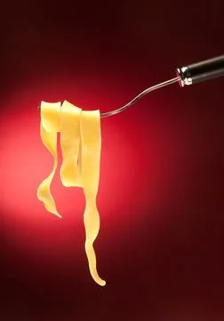 Fork with tagliatelle on a red background Stock Photos