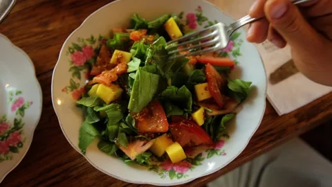 A fork takes piece of fresh vegetable salad. Stock Footage 201156127