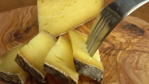 Fork takes piece of outsemi-hard cheese Video stock 74002700