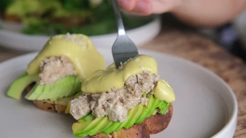 With a fork, they pick up a delicious dressing from a sandwich with fresh Stock Footage 182748156