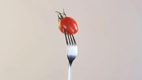 Fork With Tomato on Almond Background Stock Footage 70535141