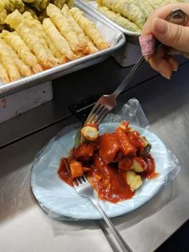 A fork with tteokbokki. Stock Photos