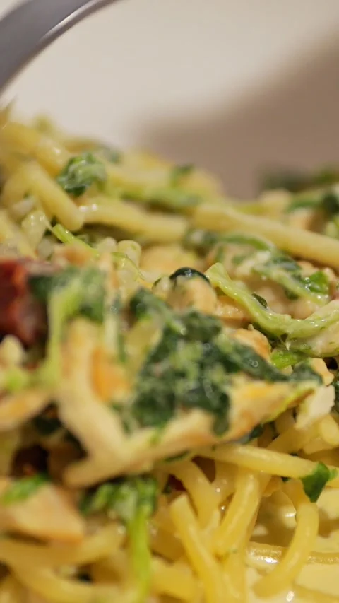 Fork Twirls Savory Spaghetti Topped With Spinach, Cheese, And Sun Dried Tomatoes 스톡 동영상 346989722