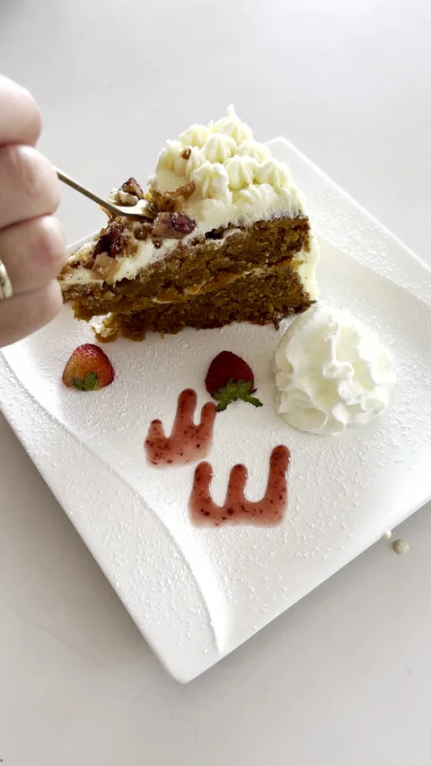 Fork used to take a piece of carrot cake on white plate at coffee shop Vídeos de archivo 339766979