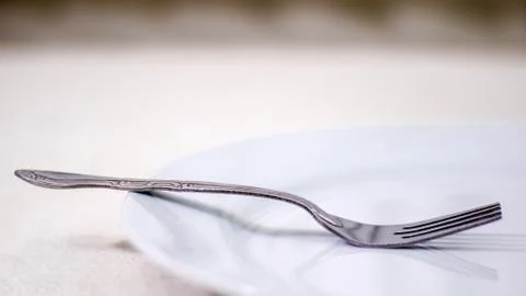 Fork On White Plate. Stock Photos