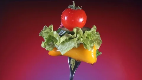 Fork with yellow pepper slices of cucumber, radish and tomato lettuce rotates Stock Footage 86611754