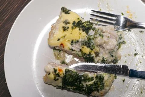 Forkbeard fish cooked with sauce and parsley , on the plate Stock Photos