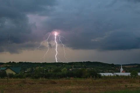 Forked lightning bolt strikes in the rural landscape of Transylvania Stock Photos