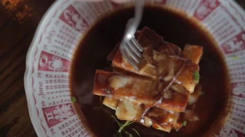 Forkful of poutine on plate w/ steam Stockbeeldmateriaal 42428703