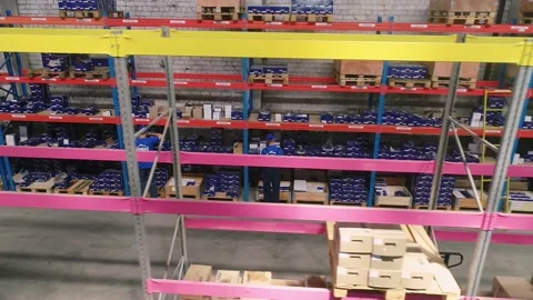 Forklift between rows of warehouse. Warehouse Workflow. Forklift in a modern Stock Footage 145540600