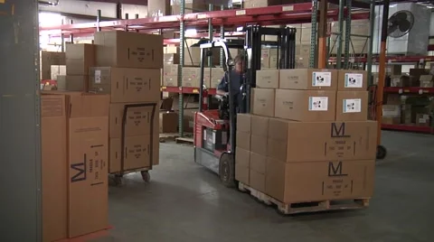 Forklift with boxes in warehouse coming around corner.mp4 Stock-Footage 63267182