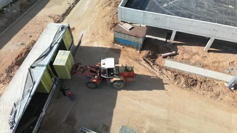 Forklift carefully unloads construction materials Stock Footage 321948271