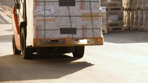 A forklift carries boxes through an open warehouse. Equipment transports goods Stock Footage 333121577