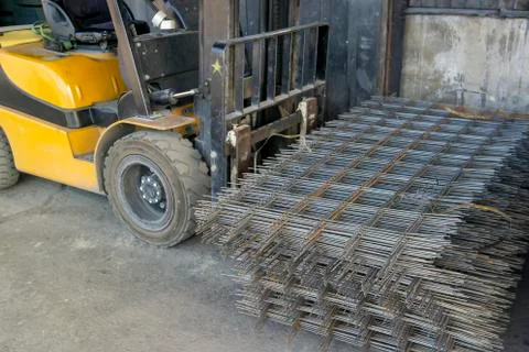 Forklift carrying a stack of rebar mesh Stock Photos