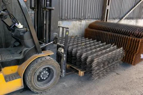 Forklift carrying a stack of rebar mesh Stock Photos