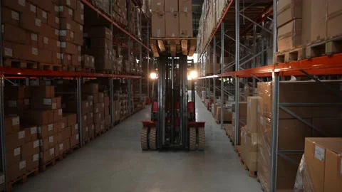 Forklift driver lifting pallet of boxes at height Stock Footage 161955902