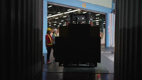 Forklift driver loading a shipping cargo container pallet with cardboard boxes 스톡 동영상 211973957