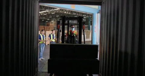 Forklift Driver Loading a Shipping Container with a Pallet and Boxes in Logistic Stock Footage 210522140