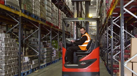 Forklift driver moving full pallet in warehouse, shot on R3D Stock Footage 67335478