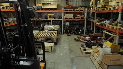 Forklift driver in protective vest driving forklift at warehouse of freight Stock Footage 82263174
